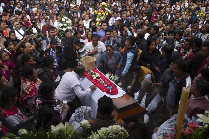 People gather around the coffin of slain Catholic priest and activist Marcelo Pérez during a mass at the main plaza in San Andrés Larráinzar, Chiapas state, Mexico, on Monday.