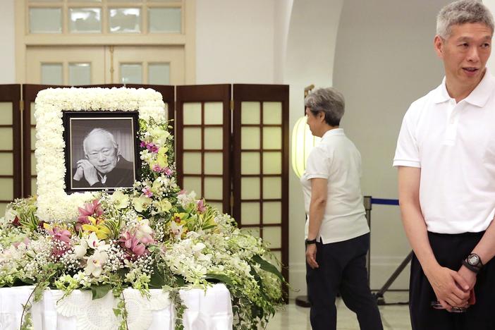 Lee Hsien Yang (right) receives friends and family members paying their respects to the late Lee Kuan Yew during a private family wake at the Istana or Presidential Palace in Singapore, March 24, 2015.