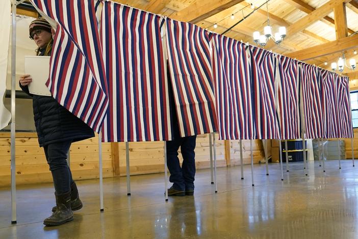 Voter leave a voting booth at The Barn at Bull Meadow in Concord, New Hampshire, during voting for the New Hampshire Primary on January 23, 2024.