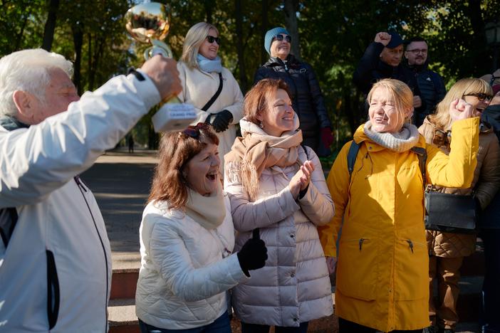 A Latvian choir, celebrating their victory in an international competition in Moldova, cheers in support of the European referendum near the Moldovan Parliament on Monday in Chișinău, Moldova.