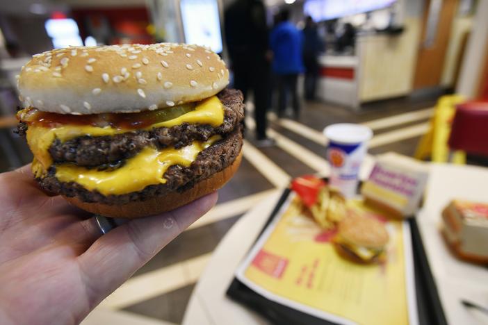 A McDonald's Double Quarter Pounder is shown on March 6, 2018, in Atlanta. The fast-food chain says customers should feel confident ordering from its restaurants despite a deadly E. coli outbreak linked to its Quarter Pounder hamburgers.