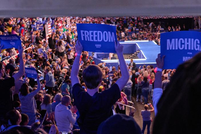Supporters watch Vice President Harris speak during a rally in Flint, Mich.