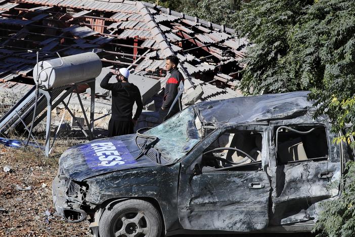 People observe the site where an Israeli airstrike hit a compound housing journalists, killing three media staffers from two different news agencies according to Lebanon's state-run National News Agency, in Hasbaya village, southeast Lebanon, on Oct. 25.