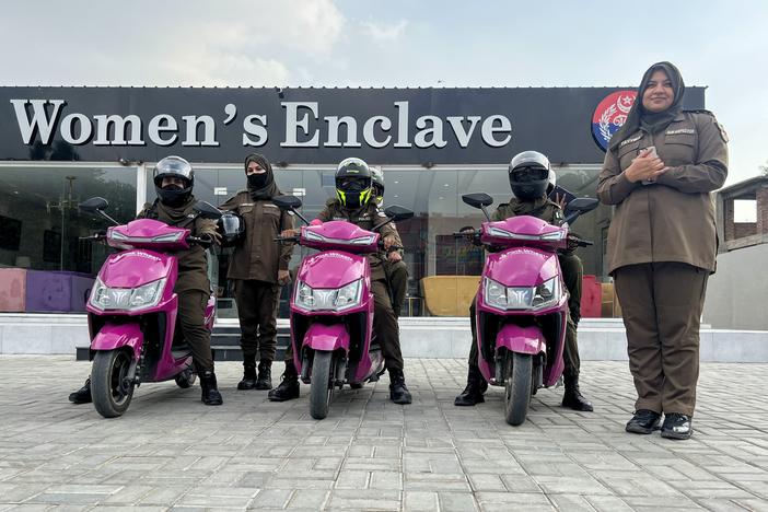 The "Pink Wheels" team in the Pakistani town of Gujranwala consists of female officers who ride pink scooters to respond to complaints from women about domestic violence and sexual assault. The officers stand in front of the "Women's Enclave," a new kind of police station, staffed by women and intended for women who want to file such complaints. At right is Tayyiba Hameed, 32, who is on the staff of the Women's Enclave.