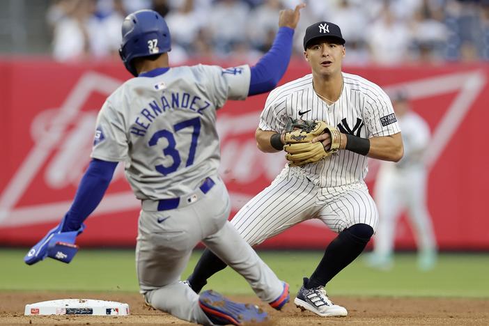 Anthony Volpe of the New York Yankees looks to complete a 2nd-inning double play after forcing out Teoscar Hernández of the Los Angeles Dodgers at Yankee Stadium on June 7 in New York City.