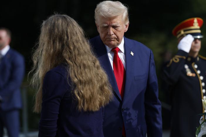 Former President Donald Trump stands alongside appears at a wreath laying ceremony at the Tomb of the Unknown Soldier at Arlington National Cemetery on August 26.