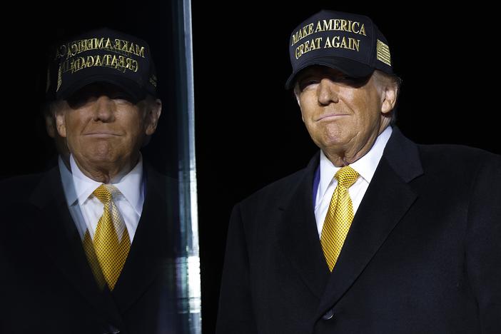 Republican presidential nominee, former President Donald Trump arrives for a campaign rally at in Traverse City, Mich., on Friday. Trump recorded the Joe Rogan Experience podcast earlier Friday and delayed his Michigan appearance by three hours.