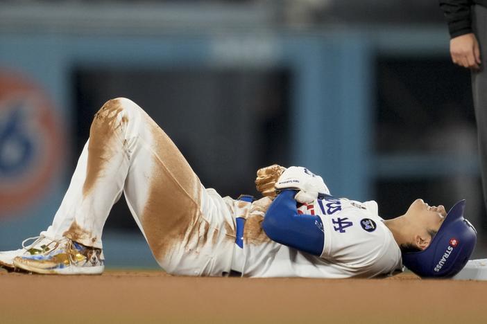 Los Angeles Dodgers' Shohei Ohtani is gets hurt sliding into second base during the seventh inning in Game 2 of the baseball World Series against the New York Yankees, Saturday, Oct. 26, 2024, in Los Angeles.