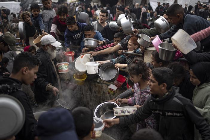 Palestinians are seen lining up for a meal in Rafah, Gaza Strip, on Dec. 21, 2023.
