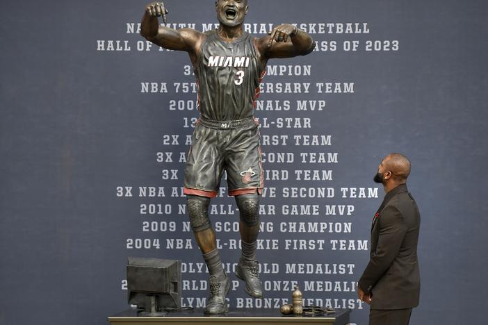 Former Miami Heat NBA basketball player Dwyane Wade looks at a bronze statue of his likeness during its unveiling ceremony outside the Kaseya Center in Miami, Fla. on Oct. 27.