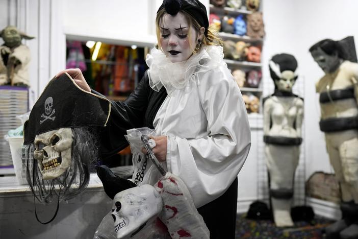 Olive Luther prepares to stock costume displays at The Theatrical Shop, Tuesday, Oct. 29, 2024, in West Des Moines, Iowa.