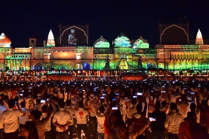 People watch a light show on the banks of river Sarayu on the eve of Diwali, the Hindu festival of lights, in Ayodhya on Oct. 23, 2022.