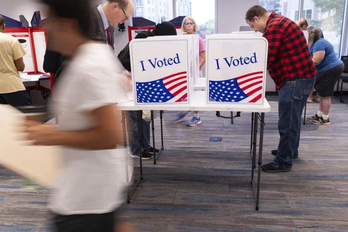 Voters work on their ballots at a polling station in Arlington, Va., on Sept. 20.
