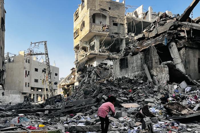 A Palestinian girl searches in the rubble of a building after an Israeli strike in Beit Lahiya, in the northern Gaza Strip, on Tuesday.