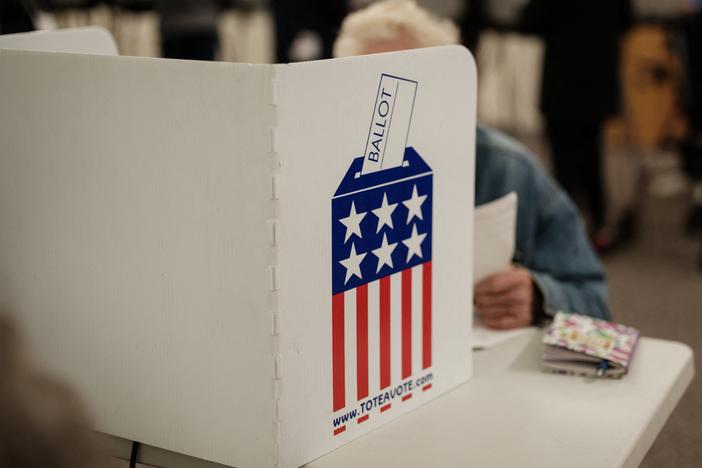 A man votes at a public library turned into an early voting polling station in Black Mountain, N.C., on Oct. 29.