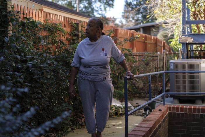 Pat Haskins, a 72-year-old retired school teacher, poses for a portrait in the backyard of her home in Silver Spring, Md., on Oct. 22.  She had struggled to keep up with repairs as her basement flooded, a bathroom floor sagged and her disabled partner needed a ramp.