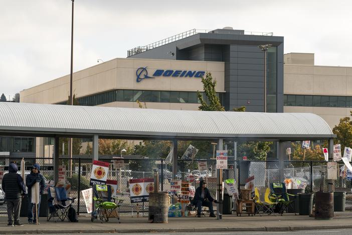 Boeing workers gather on a picket line near the entrance to a Boeing facility during an ongoing strike in Seattle, Wash. About 33,000 members of the International Association of Machinists and Aerospace Workers District 751 have been on strike for nearly seven weeks.
