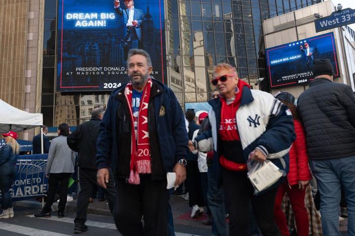 People walk by an advertisement for former President Donald Trump's campaign rally at Madison Square Garden on Oct. 27 in New York City.
