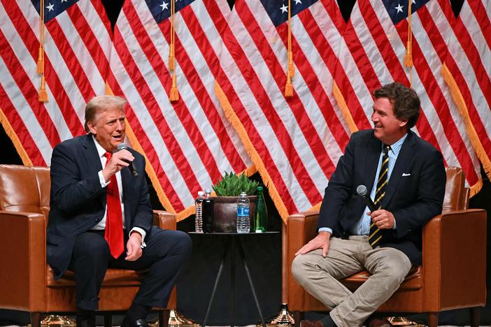 Former President Donald Trump speaks with conservative commentator Tucker Carlson in Glendale, Ariz., on Oct. 31, 2024.