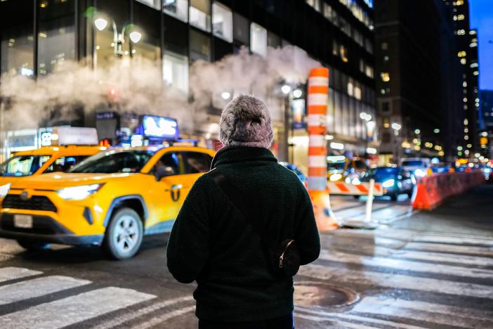 A person waits to cross Lexington Avenue in Manhattan on Feb. 21. Newly passed legislation decriminalized jaywalking in New York City.