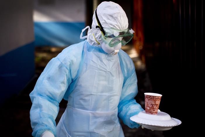 Marburg can be an exceptionally deadly virus. An outbreak in Rwanda is being handled with "unprecedented" success, say public health experts. In this photo from a 2014 Marburg outbreak in Kenya, a medical worker in protective gear carries a meal to a man quarantined in an isolation tent after coming into contact with a virus carrier.