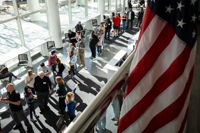 Voters line up to cast their ballots at the Stamford Government Center on the first day of early voting on Oct. 21 in Stamford, Conn.