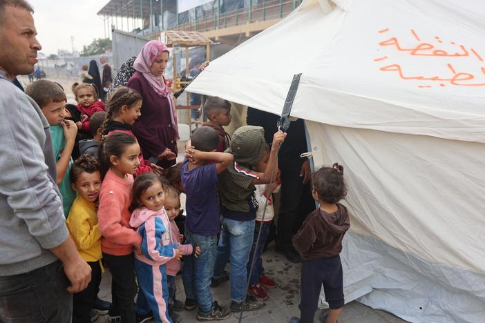 Palestinian children queue outside a tent for the second phase of polio vaccination at Abdel Aziz Rantissi hospital in Gaza City's Nasr district on Saturday.