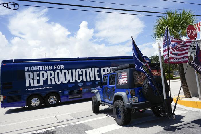 Supporters of Republican presidential nominee former President Donald Trump, who turned out to protest against abortion wait to follow the bus at the start of the "Reproductive Freedom Bus Tour" by the campaign of Democratic presidential nominee Vice President Kamala Harris and running mate Gov. Tim Walz, Tuesday, Sept. 3, 2024, in Boynton Beach, Fla.