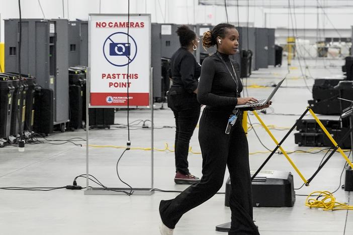 An election staffer works at the Fulton County Election Hub and Operation Center on Tuesday in Atlanta, Ga.