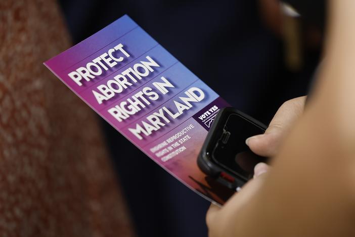 An audience member holds a brochure on abortion rights as Vice President Kamala Harris delivers remarks on reproductive rights at Ritchie Coliseum on the campus of the University of Maryland on June 24, 2024 in College Park, Maryland. Harris is speaking on the two year anniversary of the Dobbs decision, the Supreme Court ruling that overturned Roe v. Wade and struck down federal abortion protections.