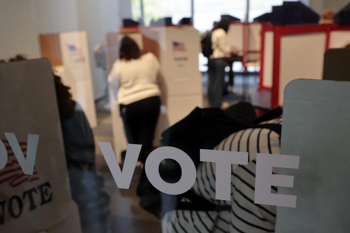 People cast their in-person early ballots for the 2024 general election at a polling station in Ann Arbor, Mich., on Thursday.