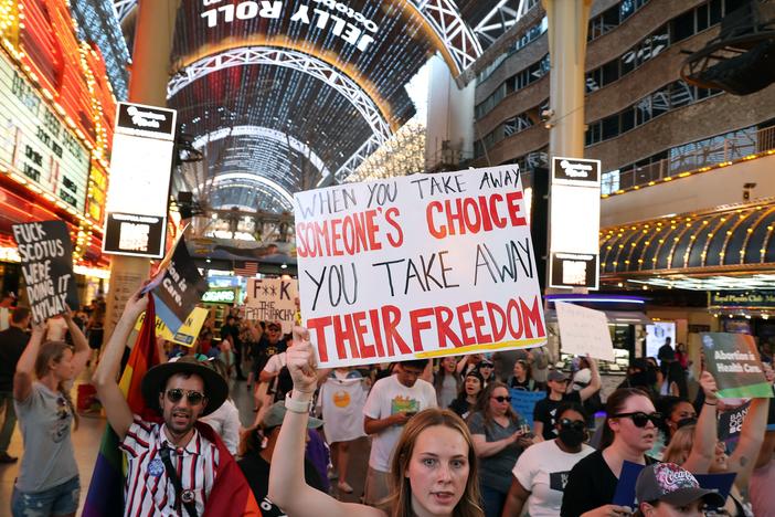 Abortion rights activists march along Fremont Street Experience as they protest the overturning of Roe Vs. Wade by the US Supreme Court, in Las Vegas, Nevada on June 24, 2022.
