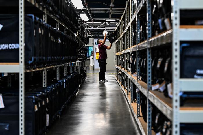 An election office worker moves bags of election supplies at the Robert L. Gilder Elections Service Center in Tampa, Florida, on November 2, 2024.