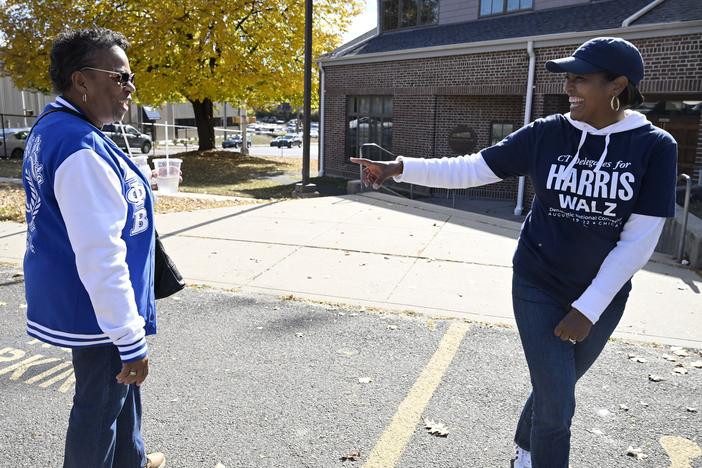 Linda Chapman, left, a member of the Zeta Phi Beta Sorority, Inc., talks with U.S. Rep. Jahana Hayes, D-Conn., at a Souls to the Polls voting rally at Grace Baptist Church on  Oct. 26 in Waterbury, Conn.
