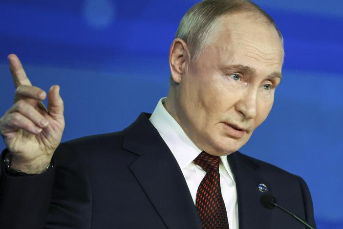 Russian President Vladimir Putin points during a meeting with foreign policy experts at the Valdai Discussion Club in the Black Sea resort of Sochi, Russia, Thursday.