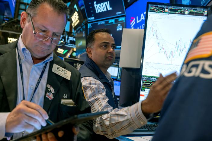 Stocks and cryptocurrencies surged after former President Trump won the presidential election. Pictured are traders working on the New York Stock Exchange in New York on Oct. 22.