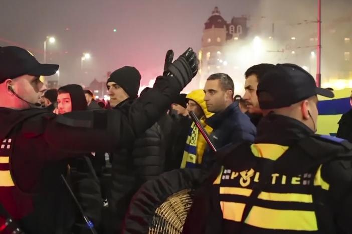 In an image taken from video, police are seen escorting Maccabi Tel Aviv soccer team supporters to the metro station, leading them to the Ajax stadium, after pro-Palestinian supporters marched near the stadium, in Amsterdam, Thursday.