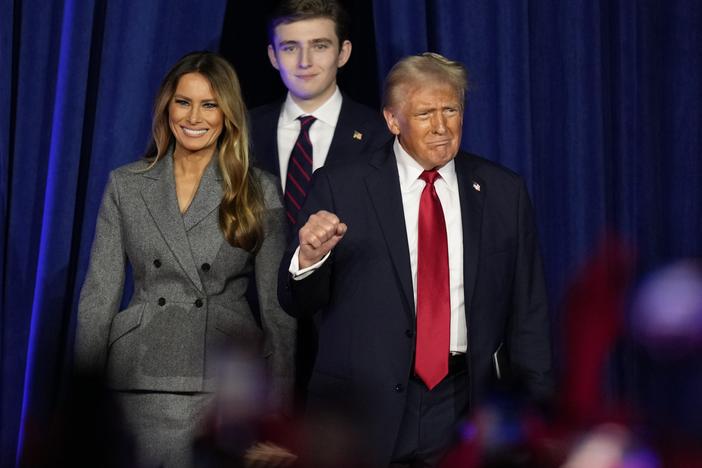 Republican presidential nominee former President Donald Trump, joined by Melania Trump, left, and Barron Trump, arrives to speak at an election night watch party on Nov. 6, 2024, in West Palm Beach, Fla.