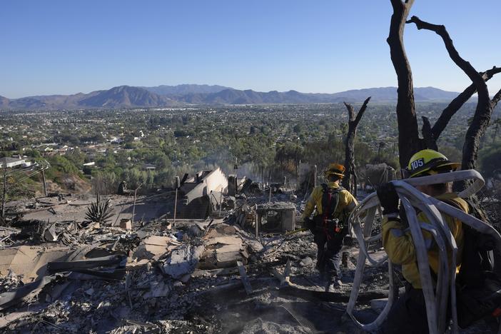 Los Angeles Fire Department firefighters work at a home destroyed by the Mountain Fire in Camarillo, Calif. on Friday.