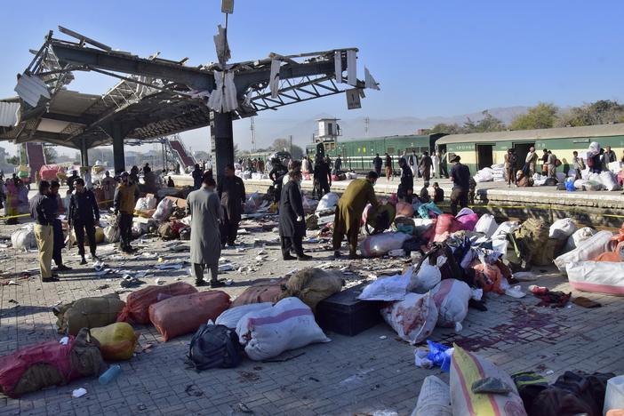 Security officials examine the site of a bomb explosion at railway station in Quetta, southwestern Pakistan on Saturday.