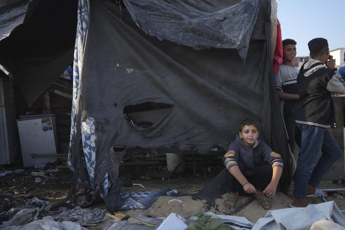 Palestinians gather at the site of an Israeli strike in the courtyard of the Al-Aqsa Hospital where displaced people live in tents, in Deir al-Balah, Gaza Strip, Saturday, Nov. 9, 2024.