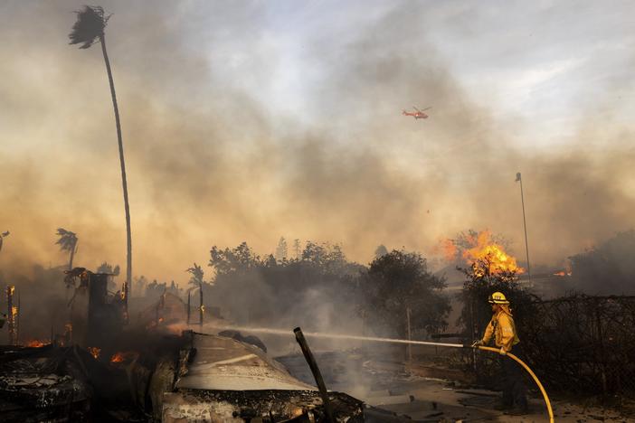 Firefighters work against the Mountain Fire on Nov. 6, 2024, near Camarillo, Calif.