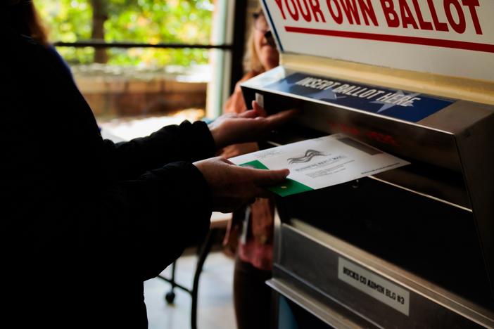 A person drops off a mail-in ballot in October in Doylestown, Pa. Pennsylvania county officials received thousands of last-minute challenges to voters’ absentee ballot applications, most of which were withdrawn shortly after Election Day.