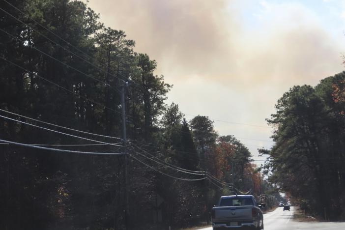 Smoke from a forest fire rises above the trees in Evesham, N.J. on Thursday, Nov. 7, 2024, when firefighters said conditions were the driest in New Jersey in nearly 120 years.