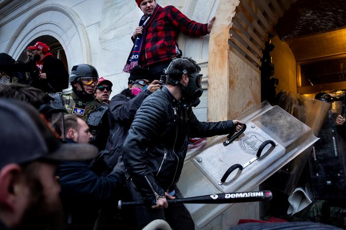 Jake Lang, center, and other Trump supporters clash with police and security forces as people try to storm the US Capitol on January 6, 2021 in Washington, DC.