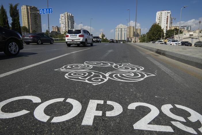 The logo for the COP29 climate change conference is painted on a road in Baku, Azerbaijan.