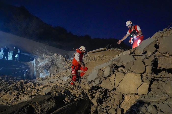 Lebanese Red Cross volunteers and other rescuers search for victims at a house that was hit in an Israeli airstrike in Baalchmay village east of Beirut, Lebanon, Tuesday, Nov. 12, 2024.