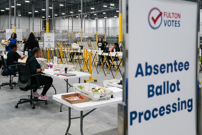 Fulton County election workers process absentee ballots on Nov. 4, in Union City, Ga.