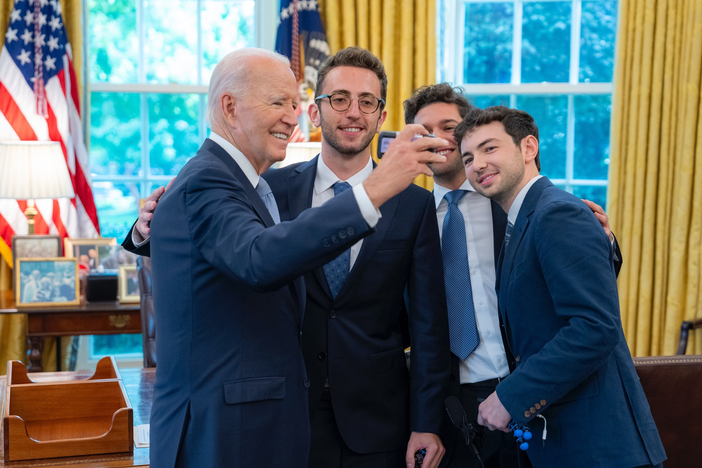 Christian Baiocco, Griffin Katz and Grant Weintrob pose for a film photo with President Joseph Biden.
