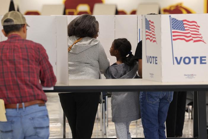 Voters gather at polling station in Oakton, Va., on Nov. 5. Parents are grappling with how to talk to their children about the election.
